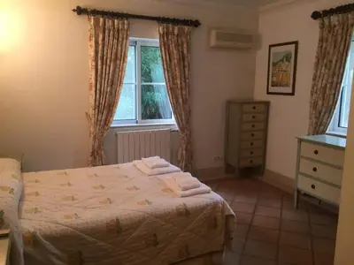 a bedroom with a bed and a dresser and a window at Villa Plaza - beautiful spacious house off roundabout 6 Quinta Do Lago in Quinta do Lago
