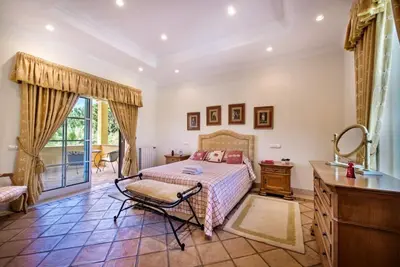 a bedroom with a bed and a dresser and a sink at Villa Plaza - beautiful spacious house off roundabout 6 Quinta Do Lago in Quinta do Lago