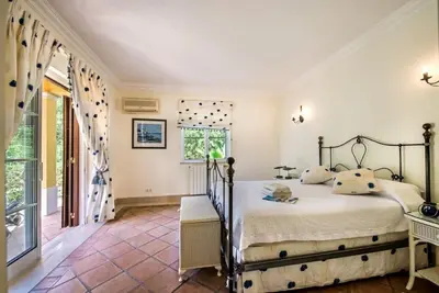 a bedroom with a bed and a large window at Villa Plaza - beautiful spacious house off roundabout 6 Quinta Do Lago in Quinta do Lago