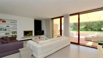 a living room with white furniture and a large window at Vila Mitri, Monte laguna-CleverDetails, 5 bedroom villa, sleeps 8 adults 2 children in Vilamoura