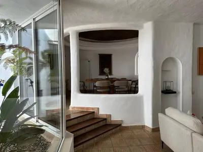 a living room with stairs and a dining room at Casa di Campara Villa Faro in Faro