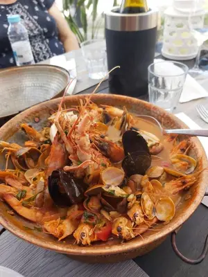 a plate of food with shrimp and mussels on a table at Albufeira - Casa Balaia Resort in Albufeira