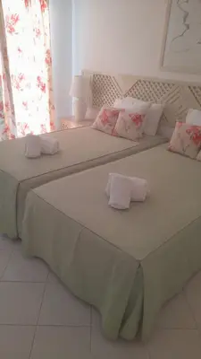two beds in a room with towels on them at Albufeira - Casa Balaia Resort in Albufeira