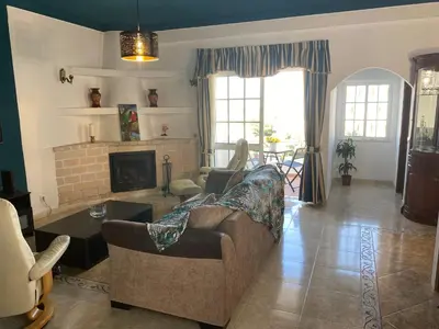 a living room with a couch and a fireplace at Moradia Olival- BBQ, 2 Quartos, Quintal in Albufeira