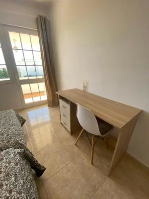 a bedroom with a desk and a bed and a desk and chair at Moradia Olival- BBQ, 2 Quartos, Quintal in Albufeira