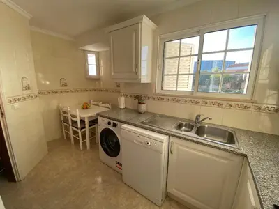 a kitchen with a sink and a washing machine at Moradia Olival- BBQ, 2 Quartos, Quintal in Albufeira