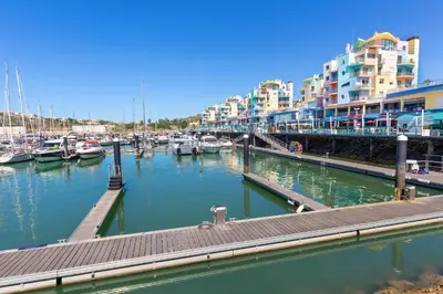 a marina with boats in the water and buildings at Pine Trees Penthouse in Olhos de Água