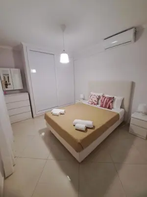 a bedroom with a bed with two towels on it at Zurrinha holidays whit jacuzzi in Quarteira