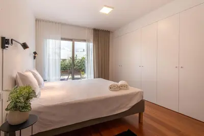 a bedroom with a large bed and a window at The Albufeira Concierge - Amazing Pool & Sunshine in Albufeira