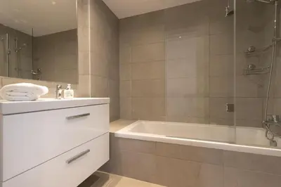 a bathroom with a tub and a sink and a shower at The Albufeira Concierge - Amazing Pool & Sunshine in Albufeira