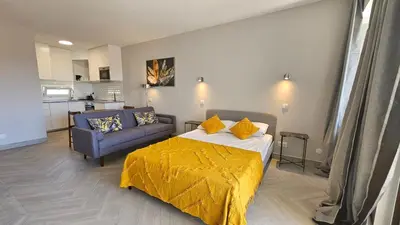 a bedroom with a bed with a yellow blanket on it at Ocean View Beach Studio Old Town in Albufeira