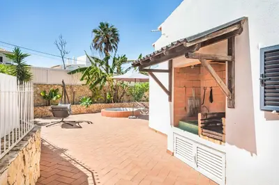 a dining room with a table and chairs and a large window at Villa Vivienda Jade in Galé