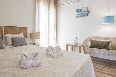 a white bedroom with a bed with bows on it at Villa Crispa in Albufeira