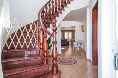 a spiral staircase in a home with a stair case at Villa Crispa in Albufeira