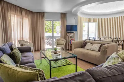 a living room with couches and a glass table at Villa Crispa in Albufeira