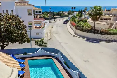 a swimming pool on the side of a road at Villa Crispa in Albufeira