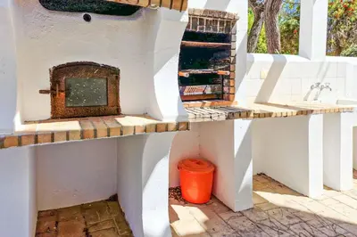 a kitchen with a counter and a sink in a wall at Villa Crispa in Albufeira