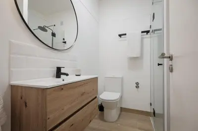 a bathroom with a sink and a mirror on the wall at Sunny Days beach apartment in Quarteira