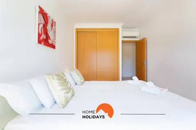 a bedroom with a white bed with white pillows at #154 V2 Vila Branca 54 by Home Holidays in Albufeira