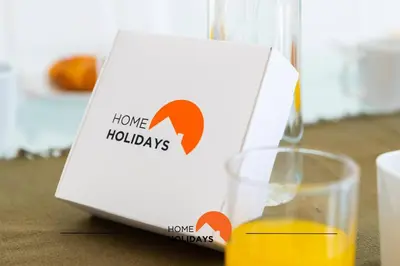 a box sitting next to a glass of orange juice at #154 V2 Vila Branca 54 by Home Holidays in Albufeira