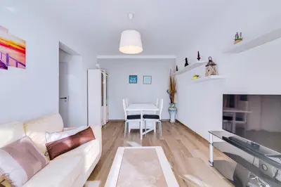 a living room with a couch and a table at Apartamento Estrela do Mar in Quarteira