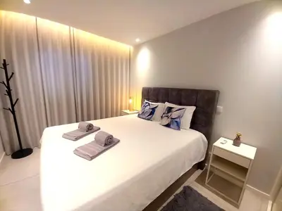 a bedroom with a large bed with towels on it at Sunlight Albufeira by Sunnyway in Albufeira