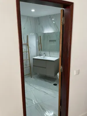 a bathroom with a sink and a mirror at A Minha Praia in Quarteira