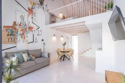 a living room with a couch and a table at LODO Suites Arco - Mezanino apartment by HD in Faro