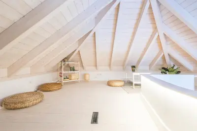 a room with straw stools in a attic at LODO Suites Ala - Studio mezanino by HD in Faro