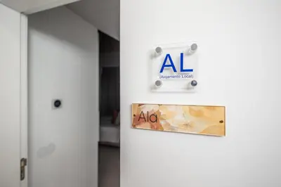 a sign on a door with an al sign on it at LODO Suites Ala - Studio mezanino by HD in Faro