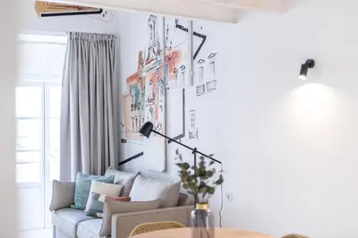 a living room with a couch and a table at LODO Suites Se - Mezanino room by HD in Faro