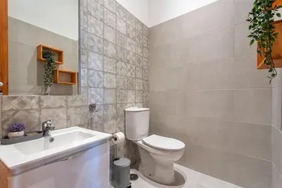 a bathroom with a toilet and a sink at Privilege Apartment Aliança da Silva in the heart of Faro in Faro