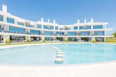 a large apartment building with a large swimming pool at Lakes 24 at Praia da Falesia Vilamoura in Vilamoura