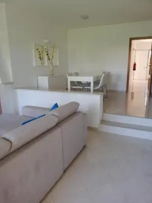 a living room with a couch and a table at Villa V2 V in Olhos de Água