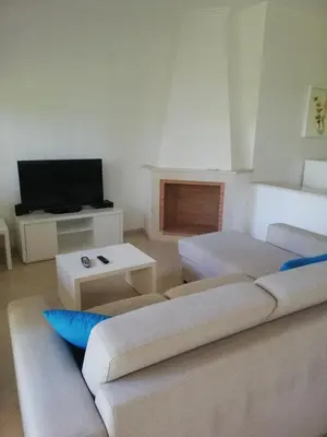 a living room with two couches and a tv at Villa V2 V in Olhos de Água