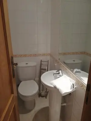 a bathroom with a toilet and a sink at Villa V2 V in Olhos de Água