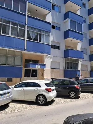 a group of cars parked in front of a building at T1 MIRA PRAIA a in Quarteira