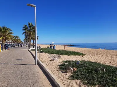 a street light on a beach next to the ocean at T1 MIRA PRAIA a in Quarteira