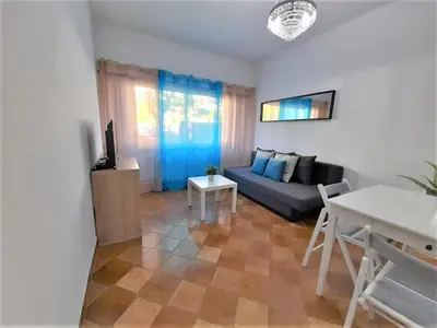 a living room with a couch and a table at T1 MIRA PRAIA a in Quarteira