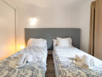 two beds sitting next to each other in a bedroom at Solar dos Pinheiros in Vilamoura