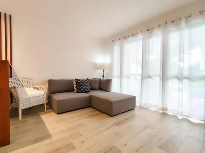 a living room with a couch and a chair at Solar dos Pinheiros in Vilamoura
