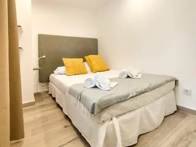 a bedroom with a bed with two towels on it at Solar dos Pinheiros in Vilamoura