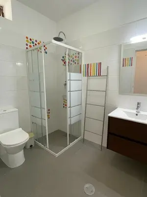 a bathroom with a shower and a toilet and a sink at A Villa in Quarteira