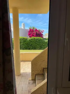 a view of a stairway from a building with pink flowers at A Villa in Quarteira