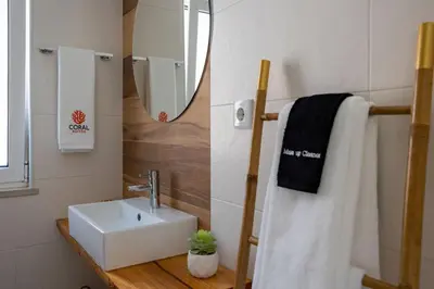 a bathroom with a sink and a mirror at Coral Boutique Suites in Albufeira