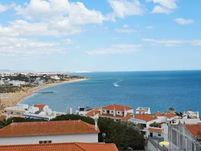 a bedroom with two beds and a table and a couch at SEAVIEW ALBUFEIRA in Albufeira