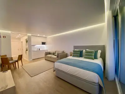 a bedroom with a bed and a living room at Marina Walk Apartment in Vilamoura