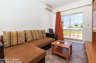 a living room with a couch and a table at Akisol Albufeira Sun in Albufeira