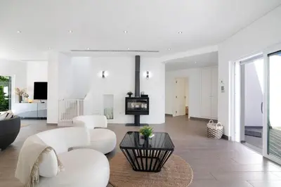 a living room with white furniture and a tv at Pine Lodge in Vilamoura