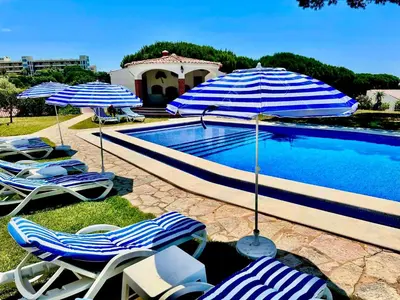 a group of chairs and umbrellas next to a pool at SOLAR DO MONTE 1 in Albufeira